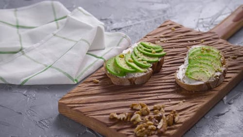 Avocado Toast on Cutting Board Picked Up