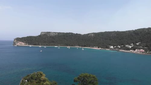 Beautiful lagoon with calm turquoise water and moored white yachts.