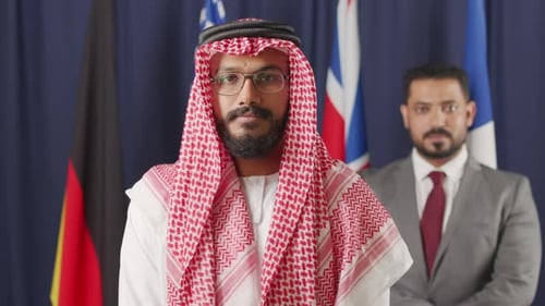 Two Men Standing in Front of Flags