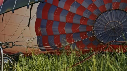 Inflating Colorful Hot Air Balloon in the Countryside