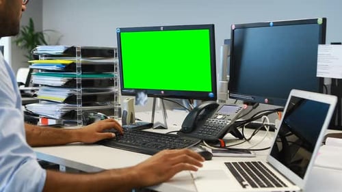 Office Worker at Desk Using Green Screen Computer