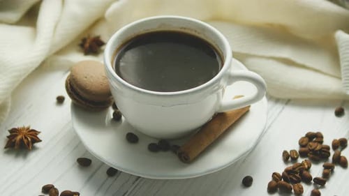 Warm Coffee with Macaroon and Cinnamon Stick