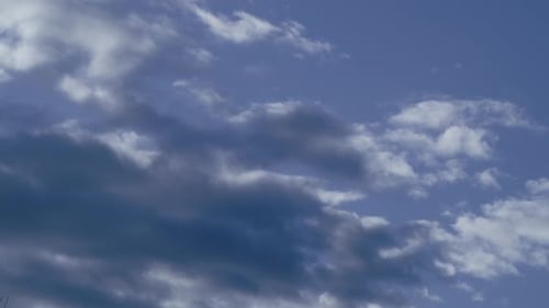 Billowing Clouds Float Across the Blue Sky