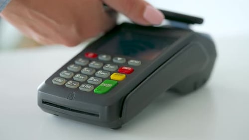 Hand Swiping Credit Card on Card Reader