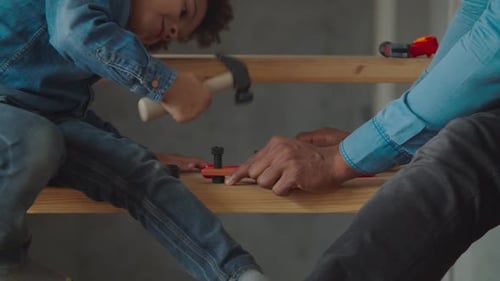 Dad Teaching Little Boy Using Toy Work Tools