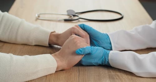 Doctor Holding Patient's Hands with Compassion