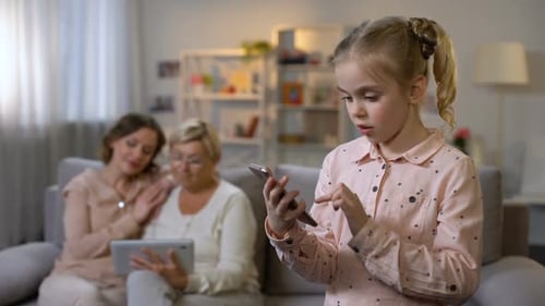 Girl Using Smartphone with Family in the Background