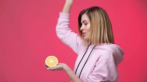 Blond Woman Holding Orange and Pink Bandana