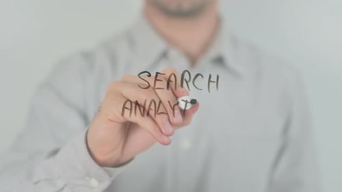 Hand Writing Search Analytics on Clear Surface