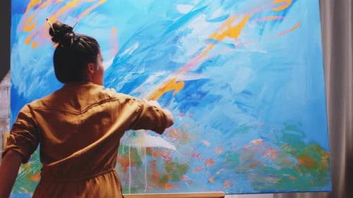 Female Artist Painting an Abstract Picture in Studio