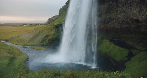 Majestic Waterfall Flowing in Lush Green Environment