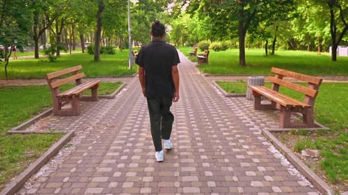 Unrecognizable Guy Going in Park