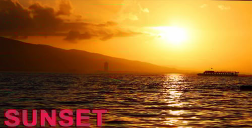 Boat Travels Across the Water at Sunset