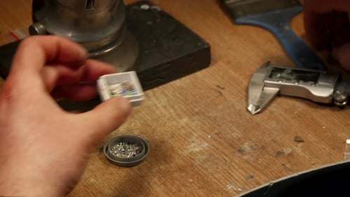 Jeweler Measures Gems on the Workshop Bench