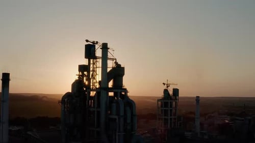 Aerial Drone Close Up View of Silhouette Cement Plant with High Factory Structure at Industrial