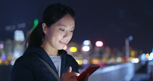 Woman Use of Mobile Phone in City at Night