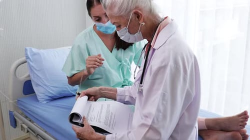Doctor and Nurse Reviewing Patient Chart in Hospital