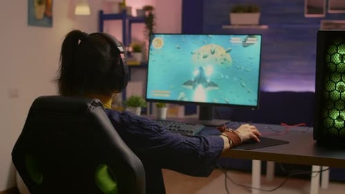 Woman Playing Space Adventure Game on Computer