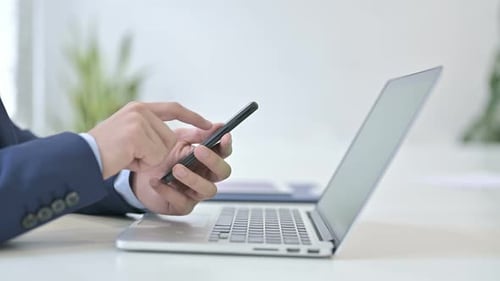 Side View of Businessman Using Smartphone