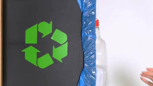 Putting recyclable waste into recycling bin