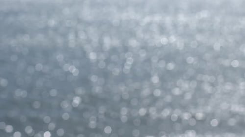 Glistening Light Reflections on Water Surface