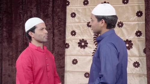 Two Men Talking and Wearing Caps