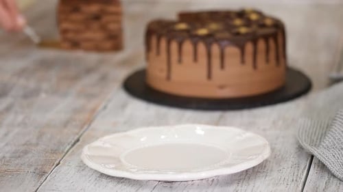 Piece of Chocolate Cake Being Placed on Plate