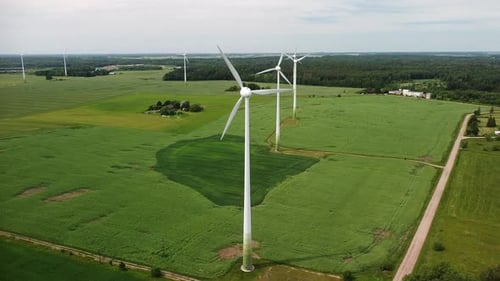 Wind Turbines Spinning in Green Rural Landscape
