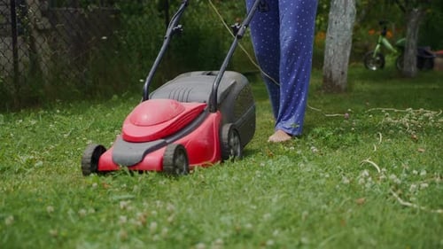 Woman Mowing Lawn
