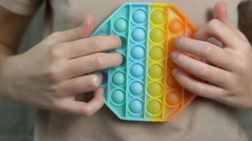 Child Pushes Bubbles on Colorful Toy