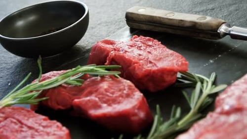 Fresh Raw Beef Steaks with Rosemary Close Up