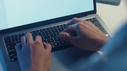 Hands Typing on Laptop Computer Keyboard Close Up