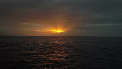 Slow Flight Above Ocean Waves Towards Beautiful Colourful Sunset, Aerial Drone Shot of Beautiful