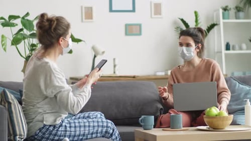 Young Adults Working on Technology Indoors with Masks