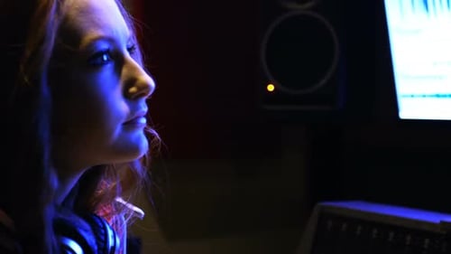 Woman Smiling in Music Recording Studio at Night