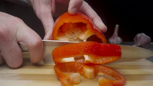 Vibrant Red Pepper Sliced on Cutting Board