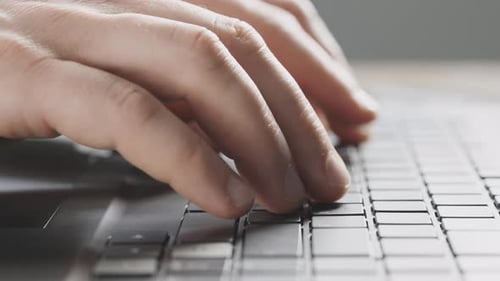 Closeup of Male Hands on a Laptop Keyboard