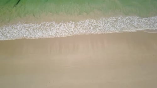 Ascending Over Sand Beach Waves and Green Sea