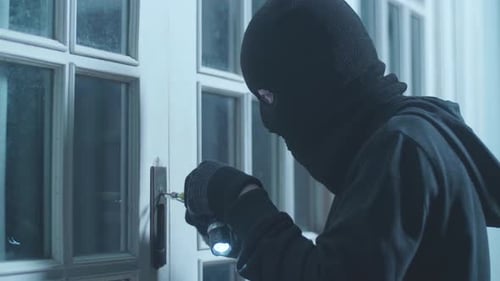 Close Up Of Thief Man Holding Flashlight Opening The Door And Entering Someone's House