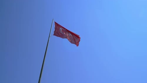 Flag Waving Against Clear Blue Sky