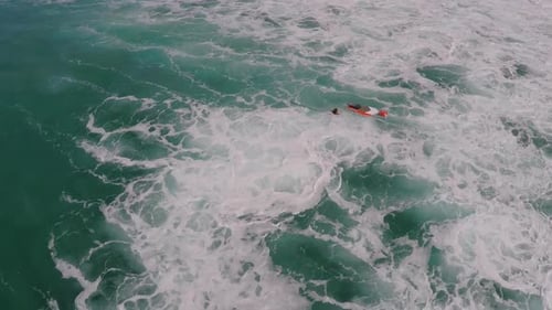 Aerial view of a man paddling while sup stand-up paddleboard surfing in Hawaii