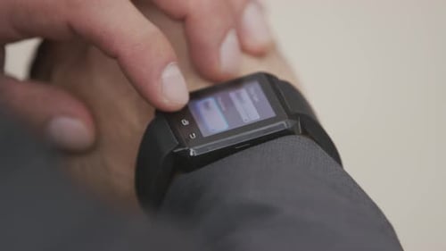 Hand Touches Screen of Smart Watch Device