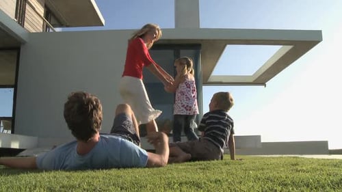 MS OF A FAMILY PLAYING IN A GARDEN