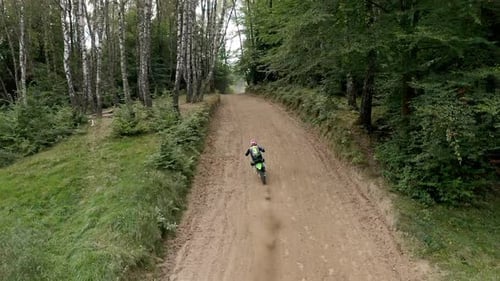 Racer On Sports Motorcycle Rides At High Speed On Dirt Road