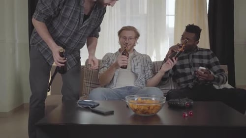 Men Enjoying Beers and Conversation at Home