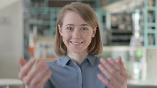 Portrait of Young Woman Pointing at the Camera and Inviting