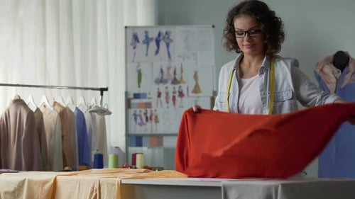 Seamstress Looking at Satin Red Fabric, Creating New Fashion Collection, Atelier