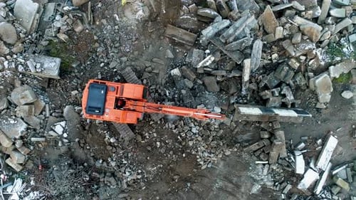 Excavator Among Rubble Aerial Birds Eye View