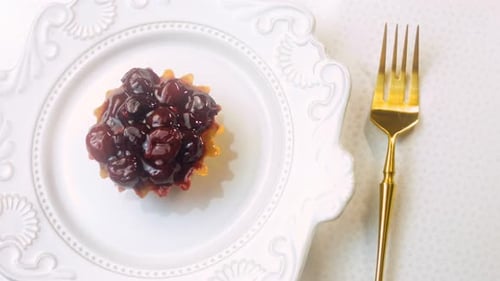 Delicious Cherry Tart on Plate with Gold Fork