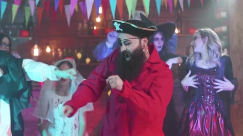Friends in Halloween Costumes Dancing Together at Party